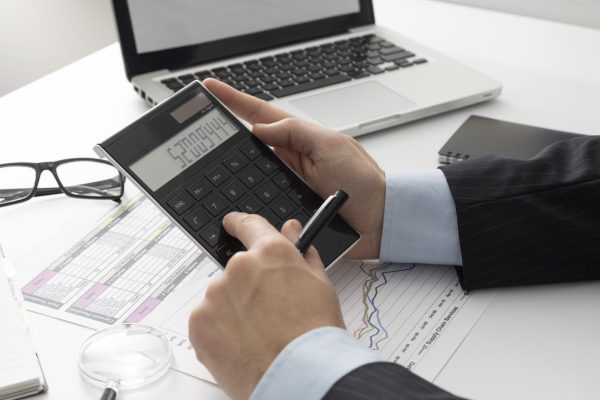 sideways-business-man-calculating-finance-numbers-1536x864